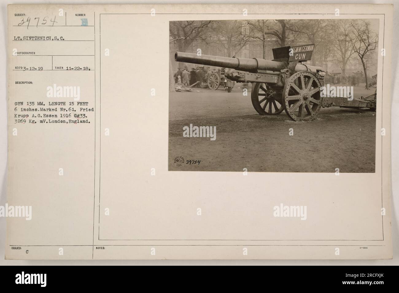 Caption: 'Lt. Sintzenich, S.C., photographer, captures an image of a 135mm gun during World War One. The gun measures 15 feet and 6 inches in length and is marked Nr. 61. Manufactured by Fried Krupp A. G. Essen in 1916, it weighs 3269 Kg. mV. This photograph was taken in London, England.' Stock Photo