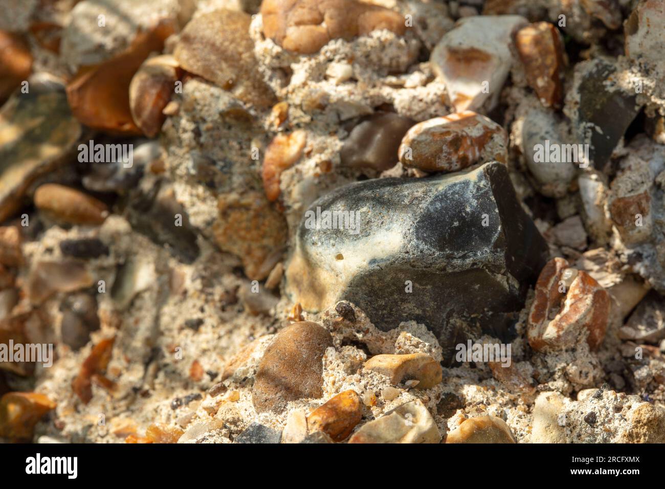 Textured semi abstract close up of section of aggregate rock in ...