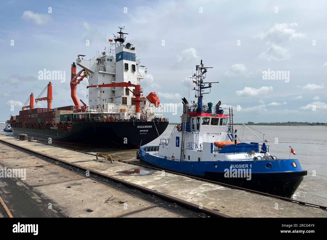 Germany. 23rd June, 2023. Navy's Military Sealift Command chartered Motor Vessel Sagamore, a container ship built in 2008, arrives at the Port of Nordenham, Germany, with the assistance of two local tugboats, June 23, 2023. The ship is loaded with cargo as part of the Defense Department's continuing support of events in Europe. Credit: U.S. Army/ZUMA Press Wire/ZUMAPRESS.com/Alamy Live News Stock Photo
