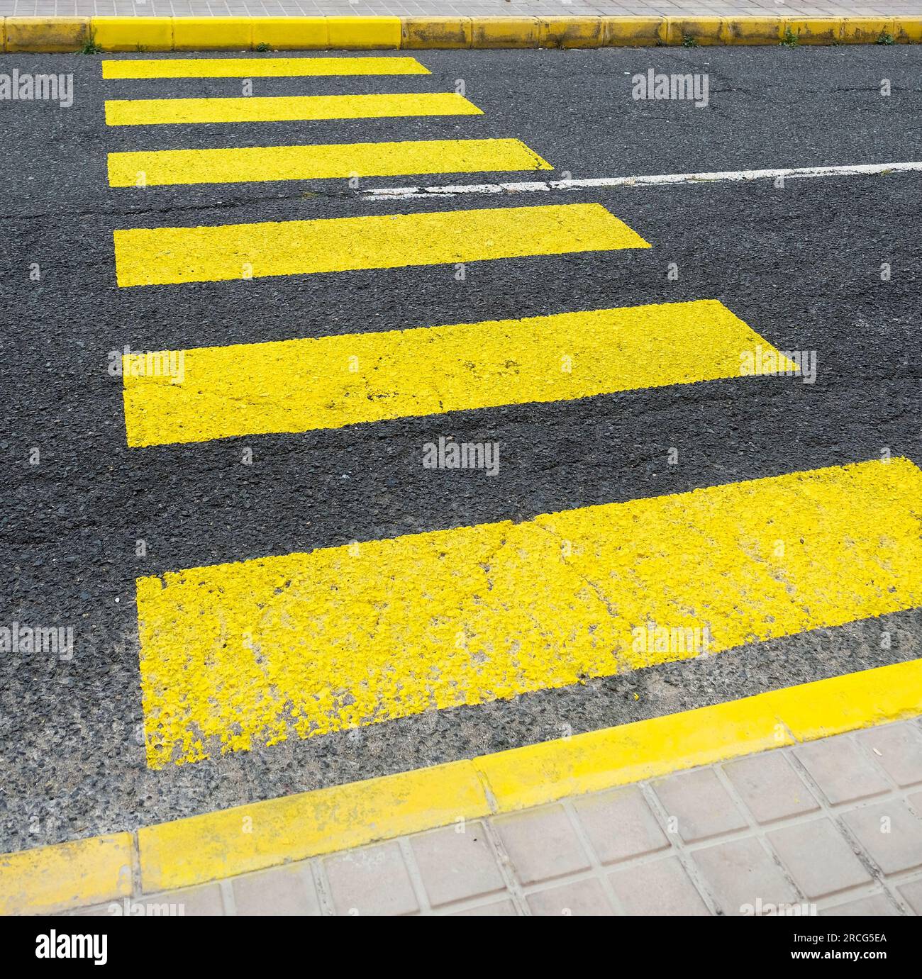 Yellow zebra crossing bands in diagonal perspective Stock Photo Alamy