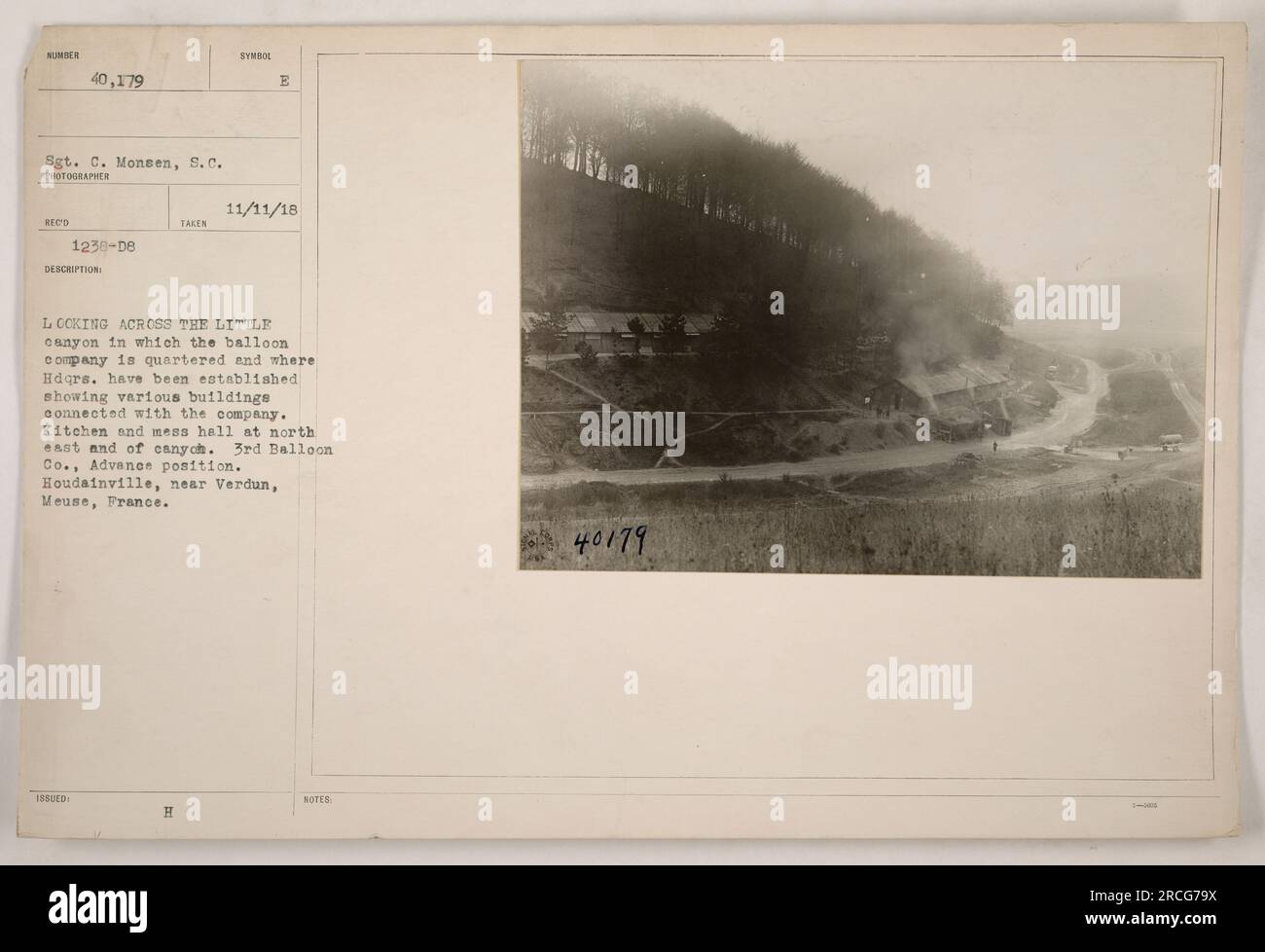 Sgt. C. Monsen takes a photograph on 11/11/18 near Verdun, France. The image shows the 3rd Balloon Company's quarters and various buildings, including a kitchen and mess hall, in a canyon. The company is stationed in an advance position in Houdainville, Meuse. The photograph is marked with the number 111-SC-40179. Stock Photo