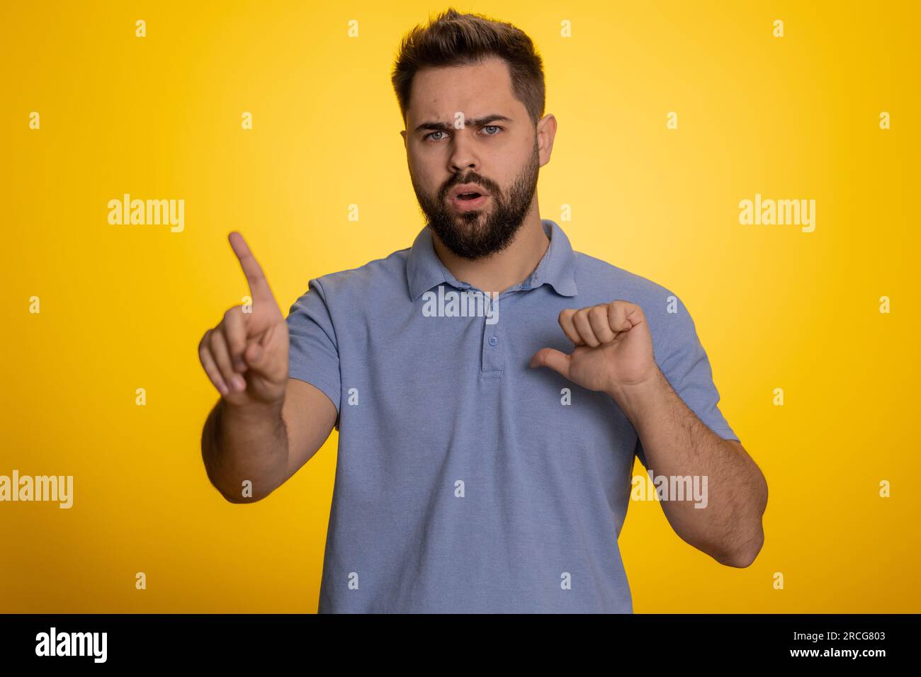 I am dont want it, not me. Confused young caucasian man pointing