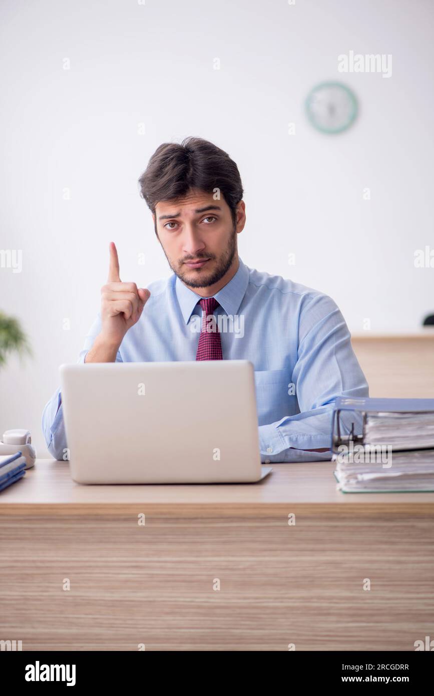 Young businessman employee sitting at workplace Stock Photo