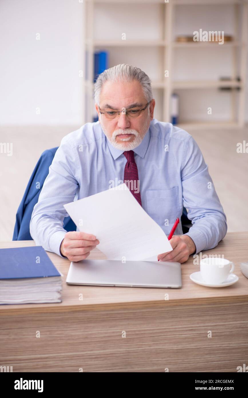 Old Employee And Too Much Work In The Office Stock Photo Alamy