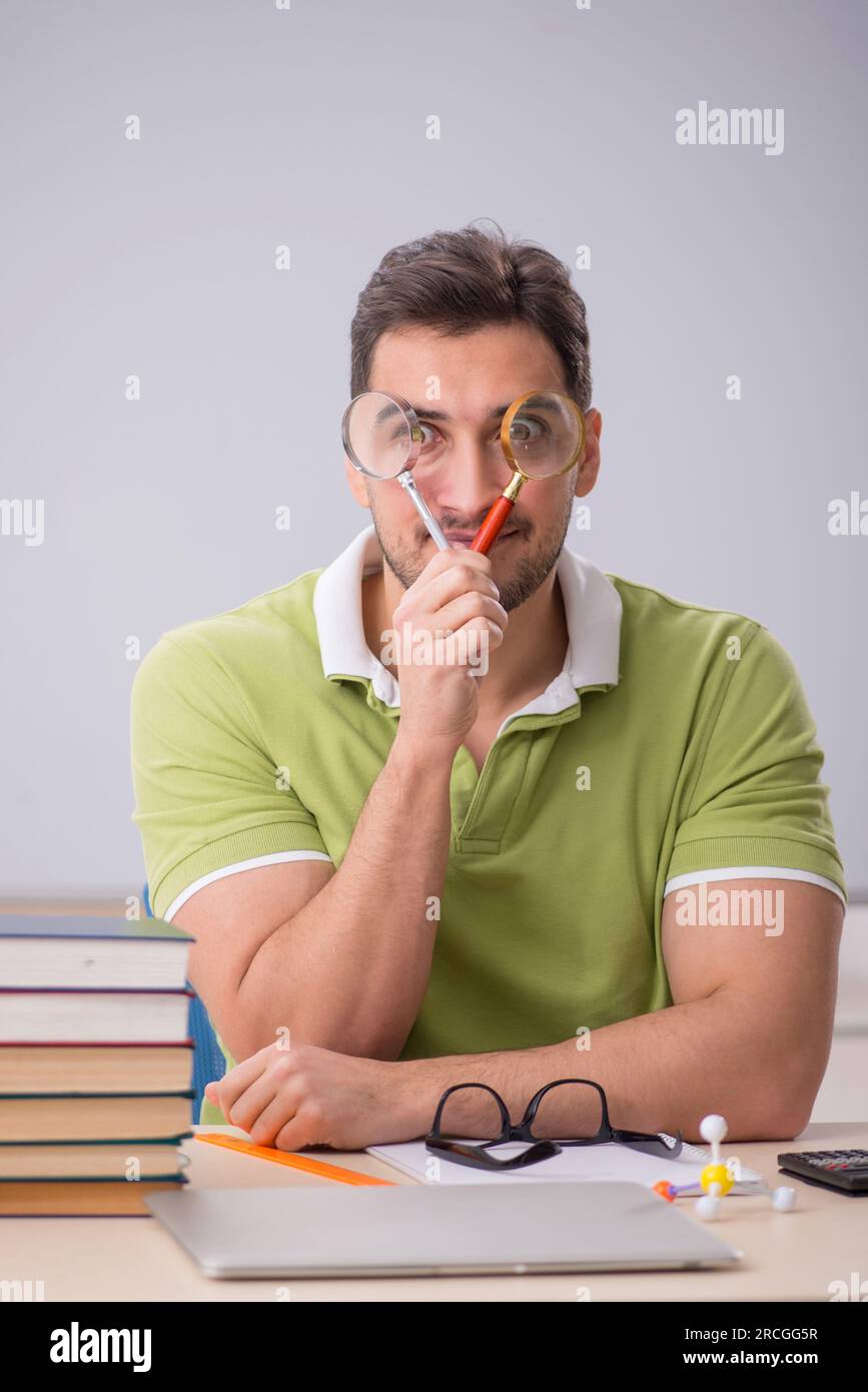 Young student preparing for exams in the classroom Stock Photo - Alamy