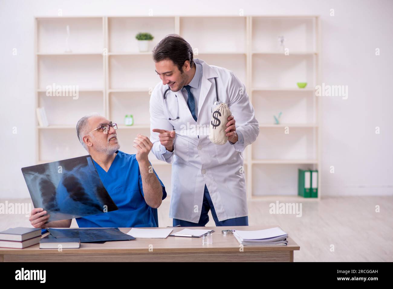 Two doctors in remuneration concept Stock Photo