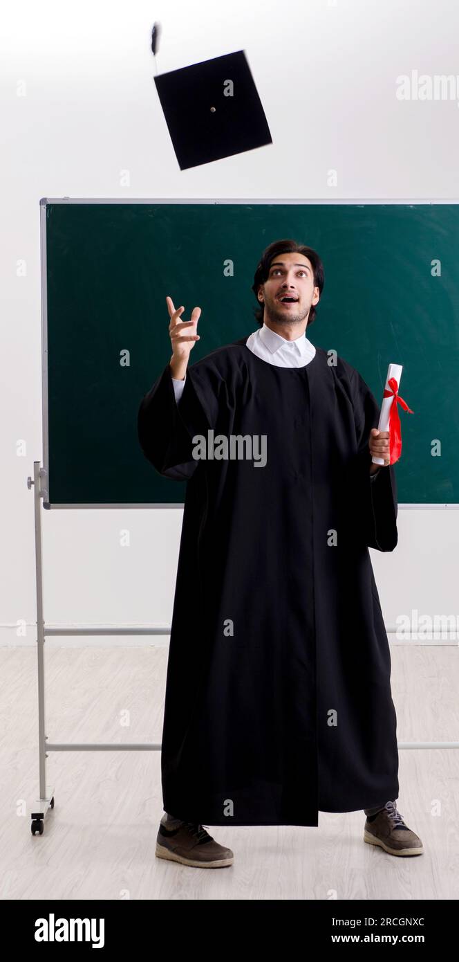 Graduate Front Use The graduate student in front of green board Stock Photo - Alamy