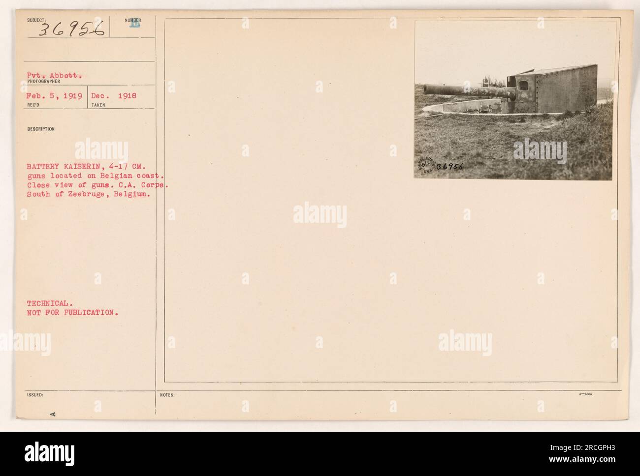 This photograph depicts Pvt. Abbott standing near the 4-17 CM guns of Battery Kaiserin, located on the Belgian coast during December 1918. The image offers a close view of the guns and is part of the collection of American Military Activities during World War One. It falls under the category of technical use and is not meant for publication. The picture was taken by an unidentified photographer and received on February 5th, 1919. Stock Photo