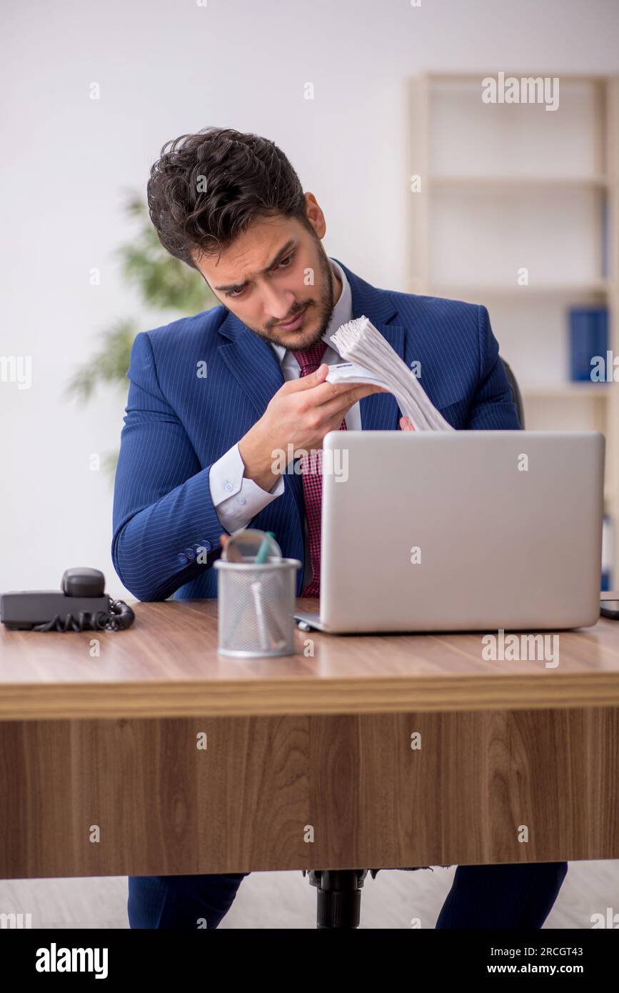 Young employee sitting at workplace Stock Photo
