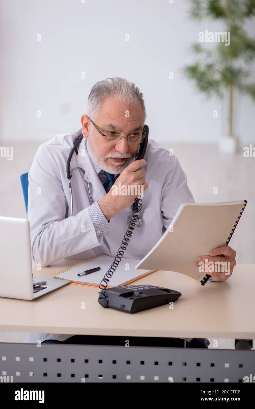 Old doctor in telemedicine concept Stock Photo