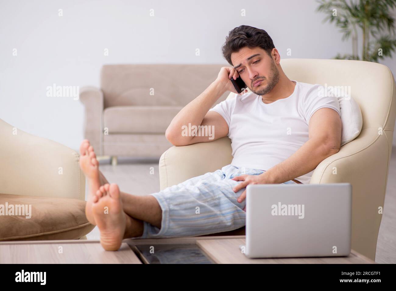 Young lazy man starting day at home Stock Photo