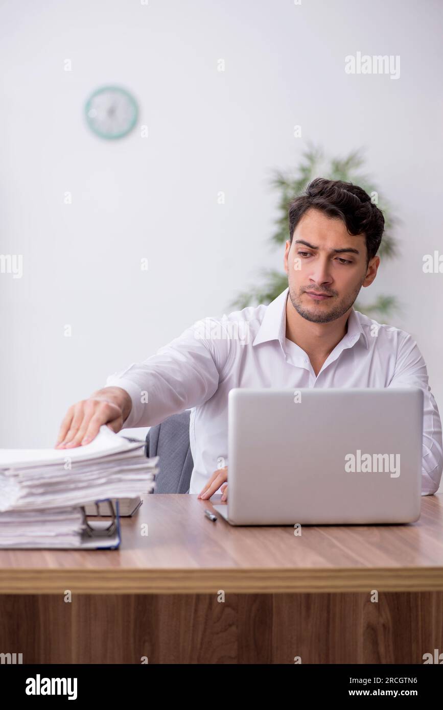 Young employee sitting at workplace Stock Photo