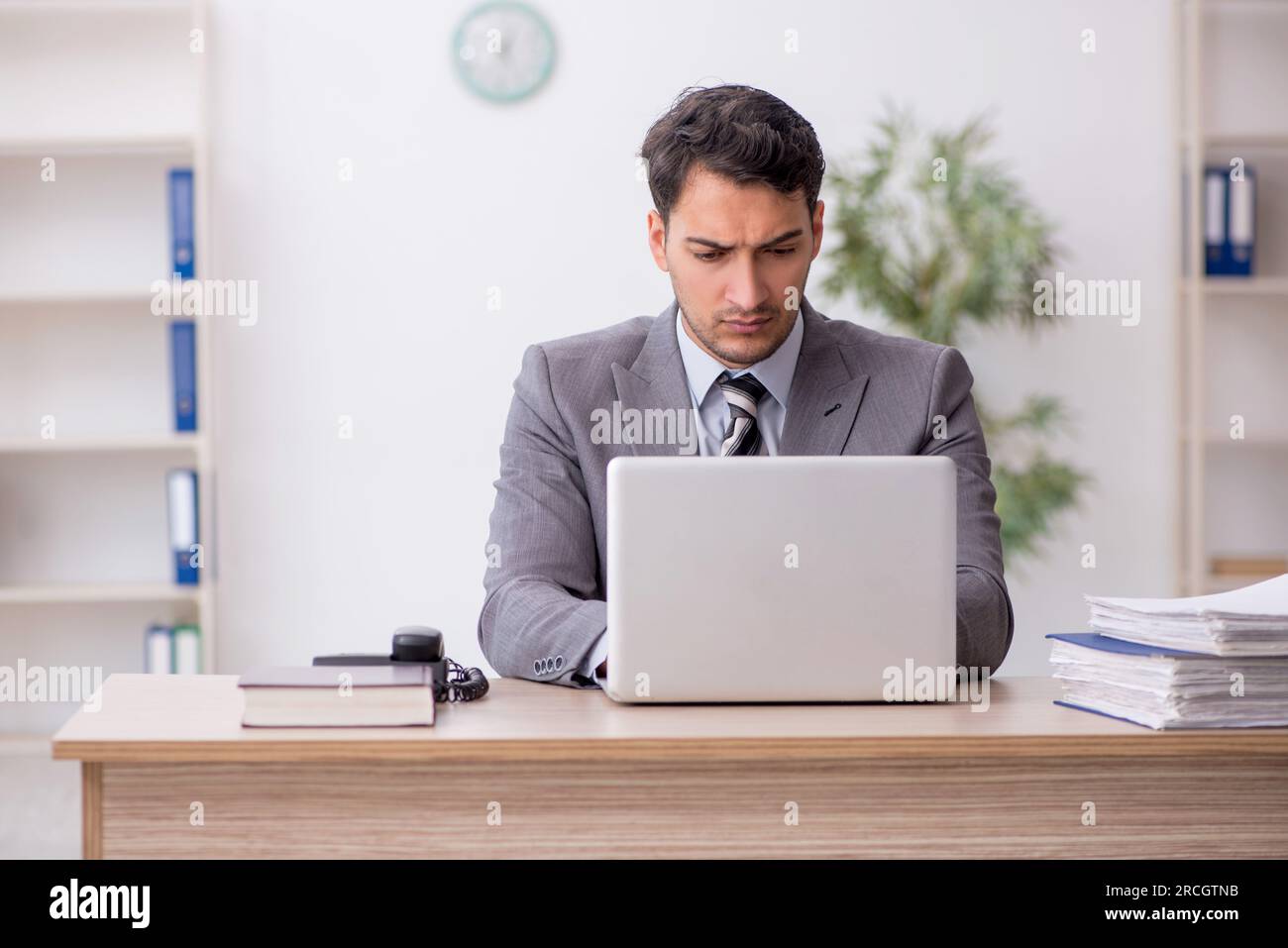 Young employee sitting at workplace Stock Photo