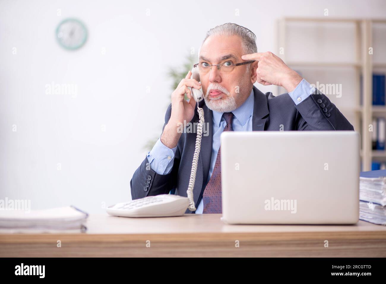 Old employee working in the office Stock Photo