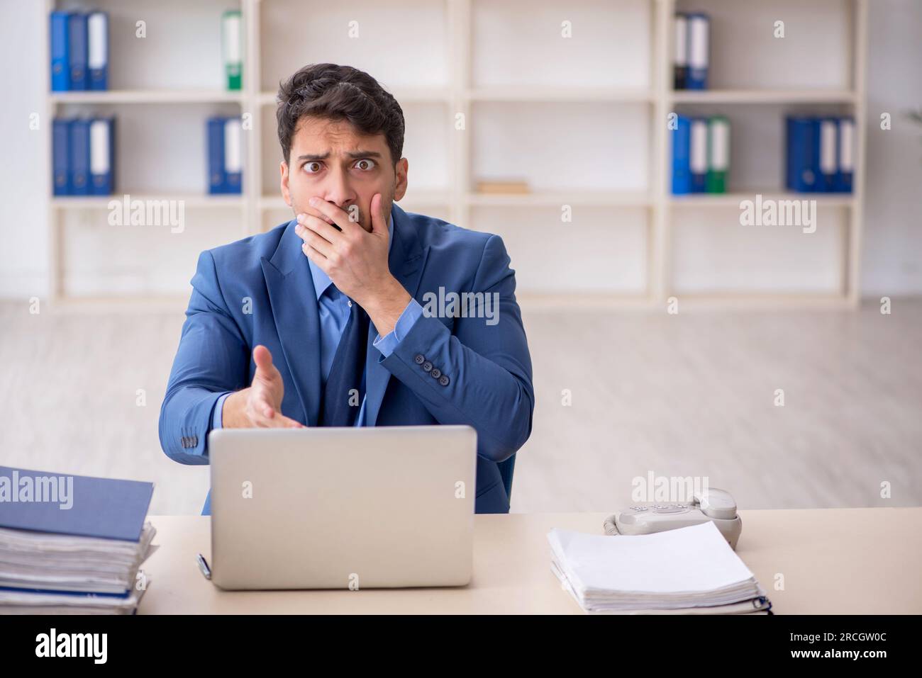 Young employee working at workplace Stock Photo