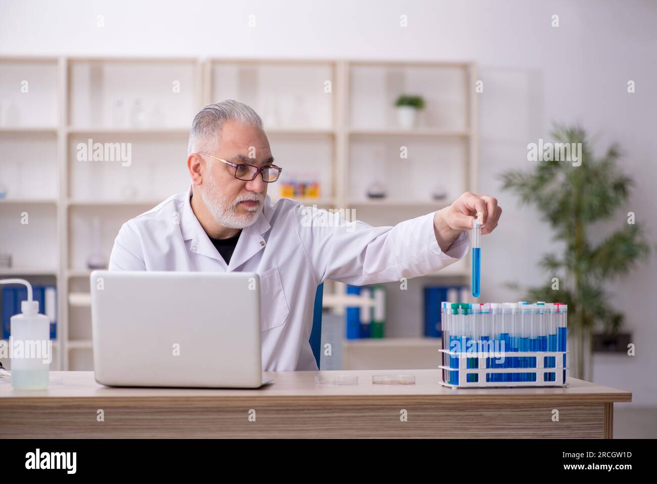 Old chemist working at the lab Stock Photo
