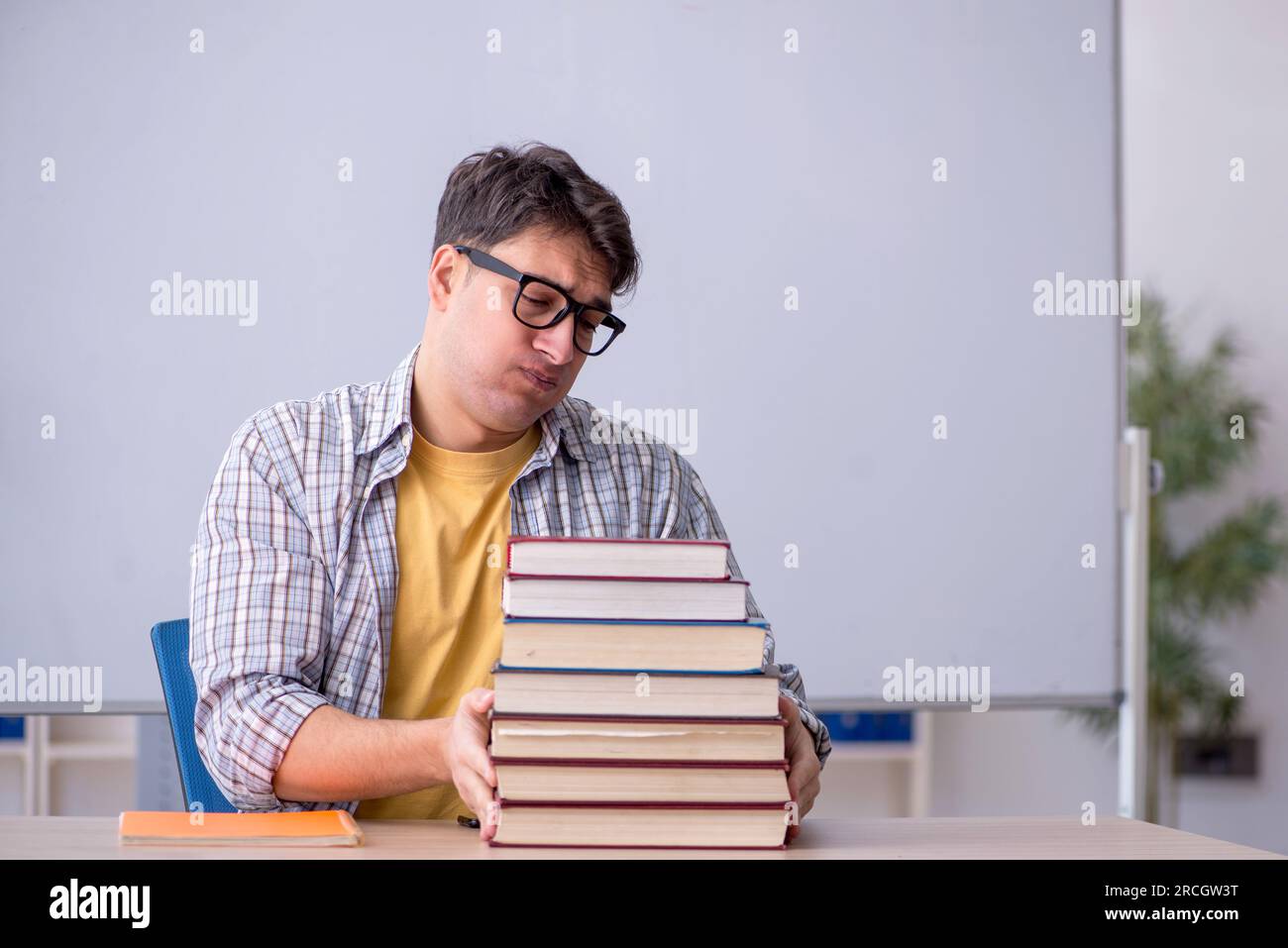 Young student preparing for exams in the classroom Stock Photo