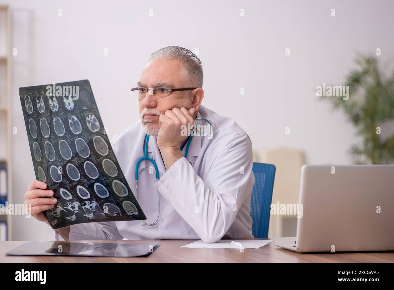Old doctor radiologist working in the clinic Stock Photo