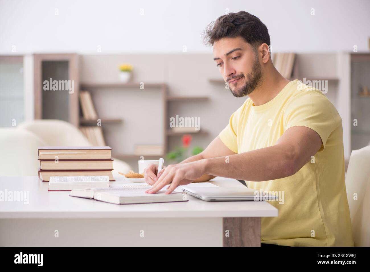 Young student studying at home during pandemic Stock Photo