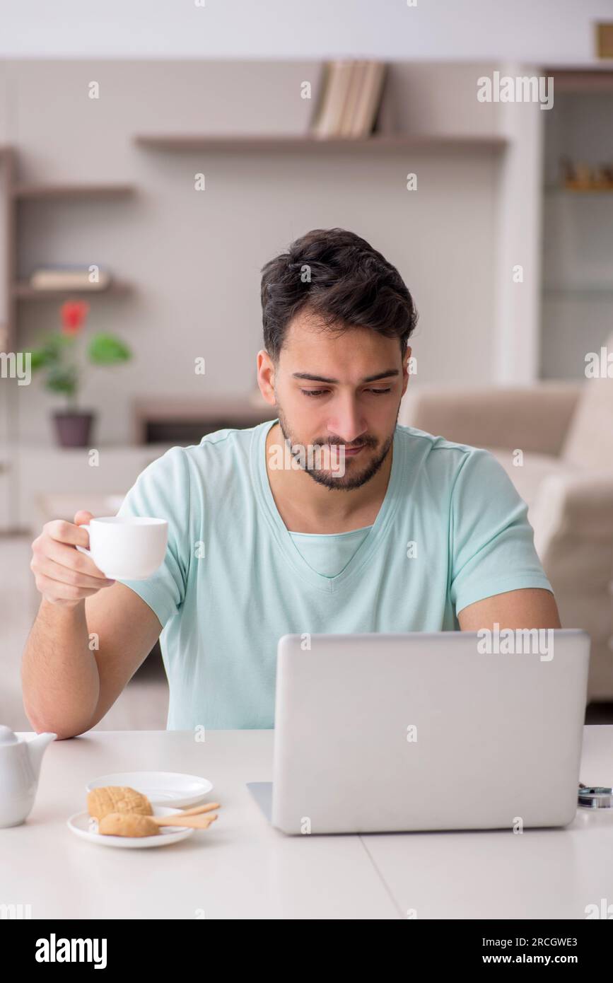 Young freelancer working from home during pandemic Stock Photo
