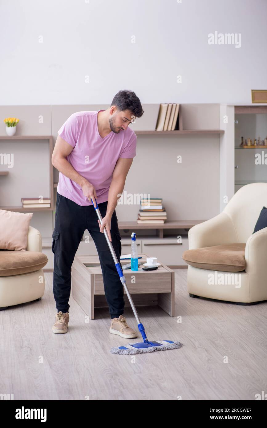 Young contractor cleaning the house Stock Photo