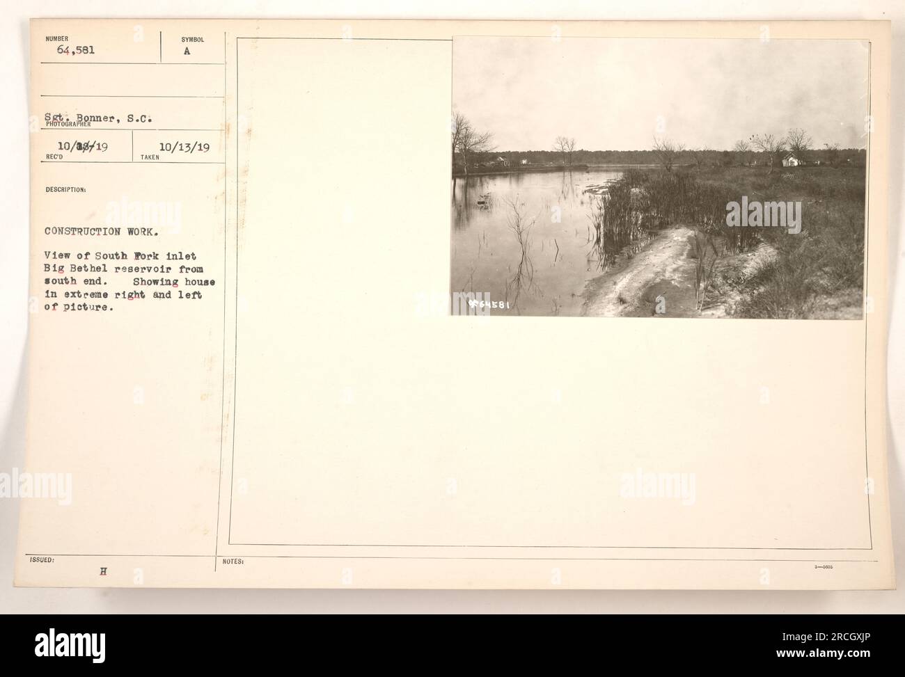 Photograph taken on October 8, 1919, by Sergeant Ronner in South Fork inlet, Big Bethel reservoir. The image depicts construction work with a view of the reservoir from the south end, showcasing houses on the extreme right and left. The photo bears the identification number 965481 and includes an annotation indicating it was taken as part of reconnaissance on October 13, 1919. Stock Photo