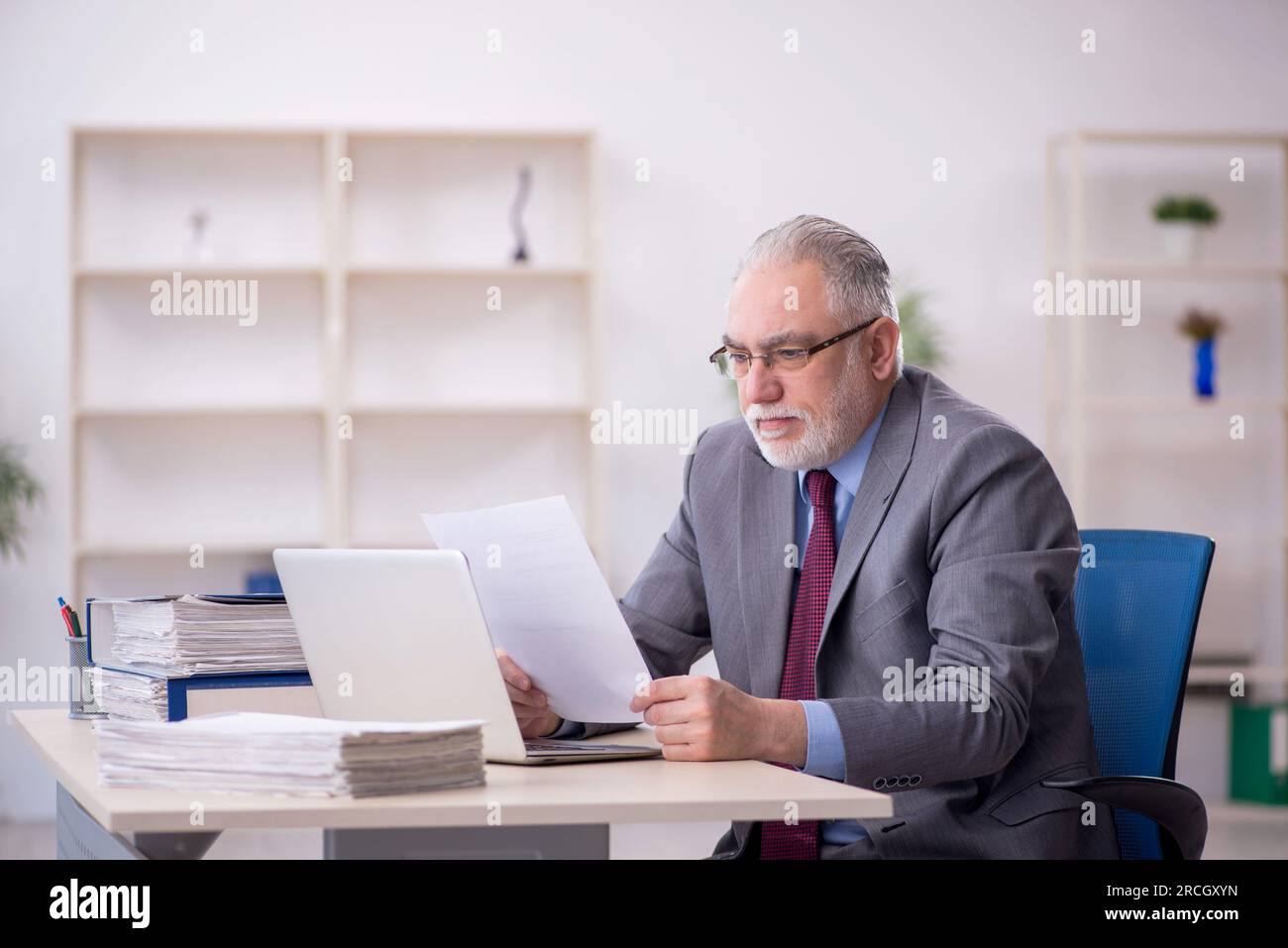 Old businessman employee working at workplace Stock Photo - Alamy