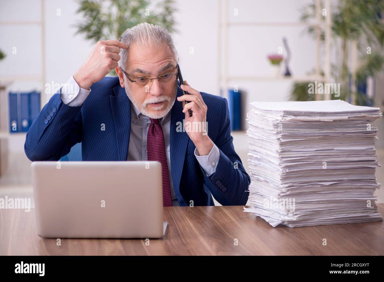 Old businessman employee working at workplace Stock Photo - Alamy