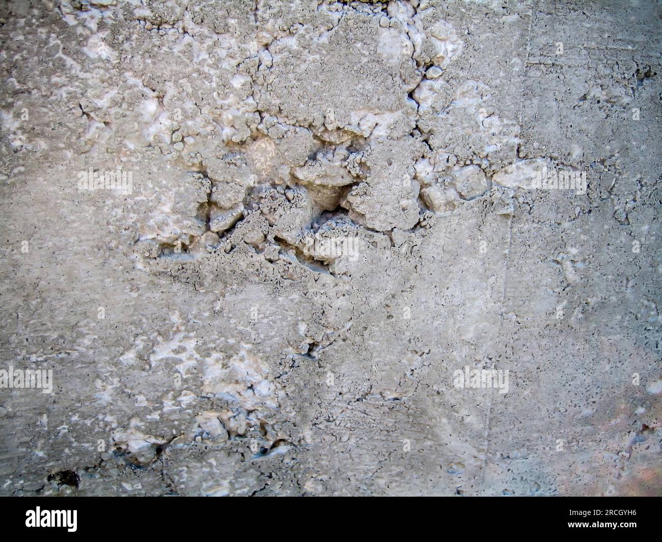Air pocket in a concrete wall caused by clumped aggregate Stock Photo