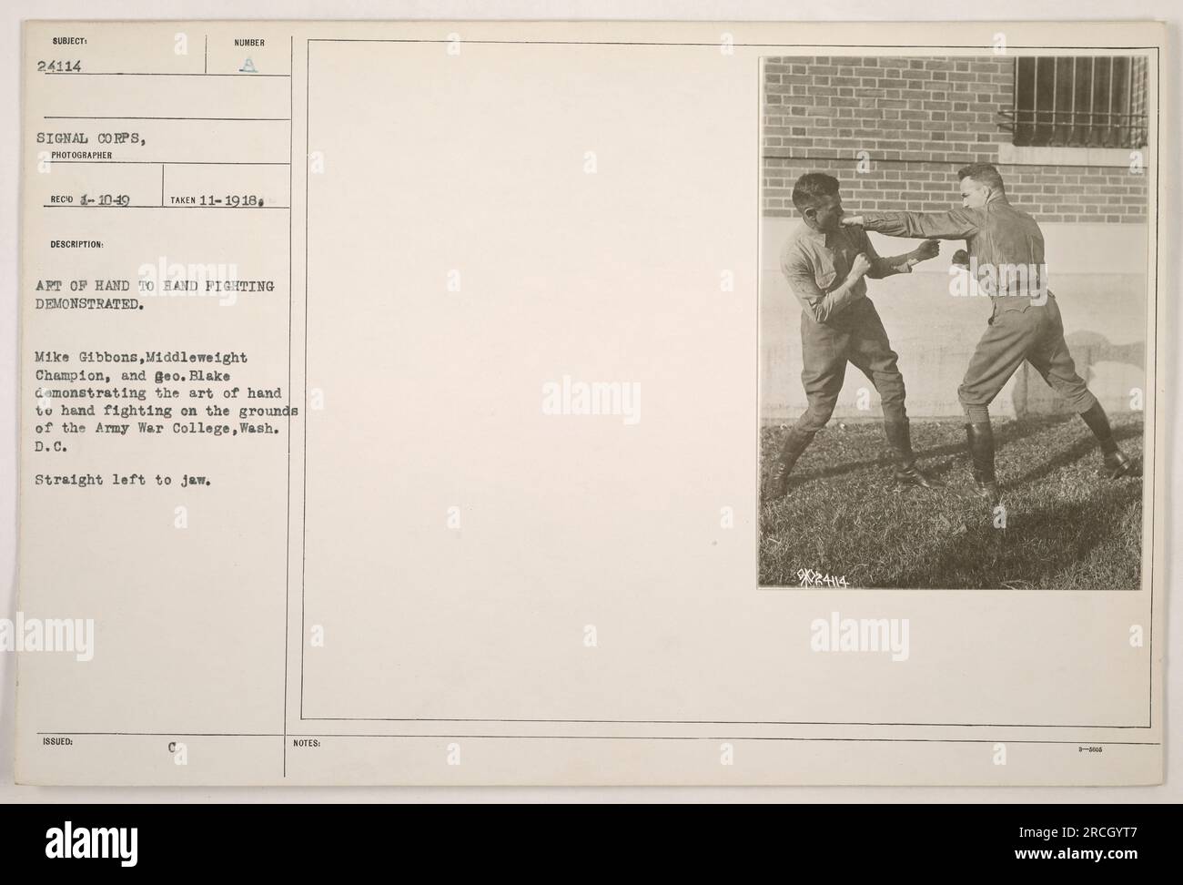 Image capturing Mike Gibbons, the Middleweight Champion, and geo. Blake showcasing hand-to-hand combat techniques at the Army War College in Washington D.C. They are seen demonstrating a straight left punch to the jaw. Photograph taken in November 1918. Stock Photo