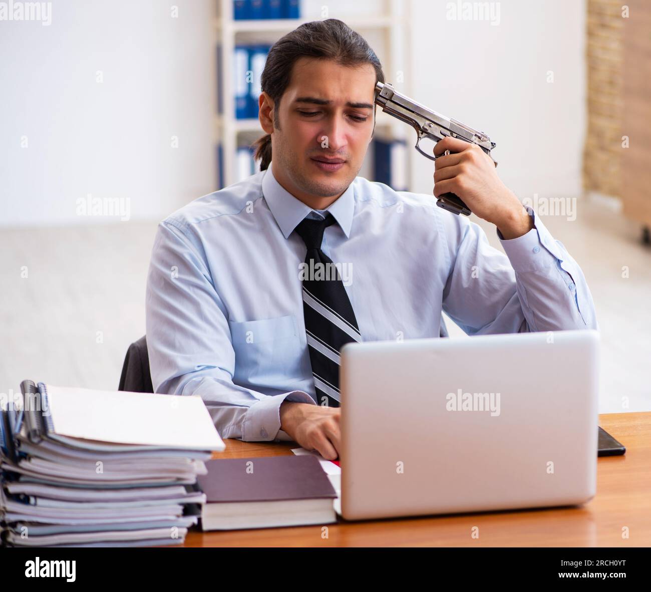 Depressed employee committing suicide at workplace Stock Photo - Alamy