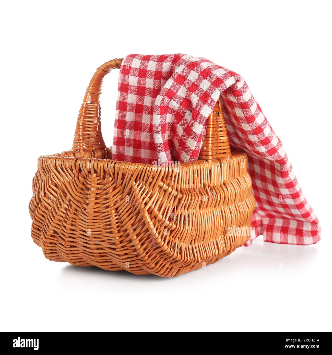 Wicker picnic basket with red checkered napkin isolated on white ...