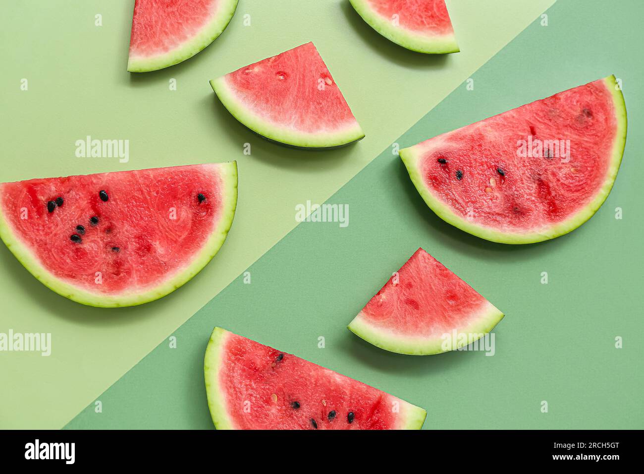 Pieces of fresh watermelon on green background Stock Photo - Alamy