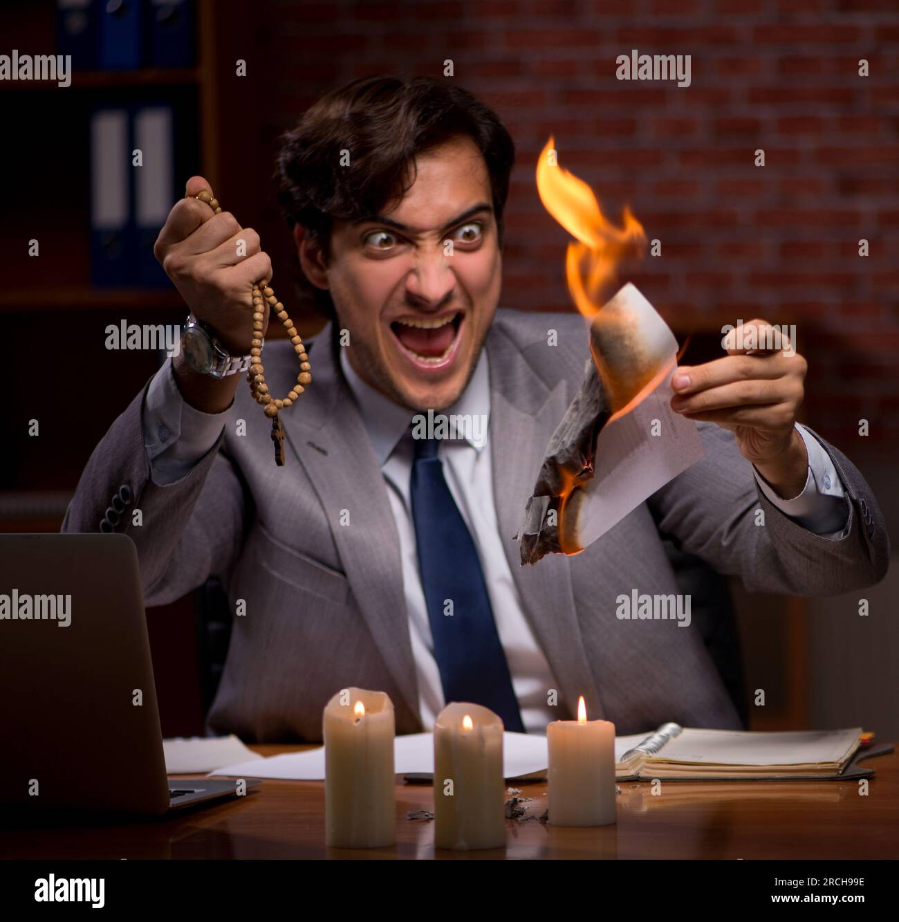 The businessman burning the evidence late in office Stock Photo - Alamy