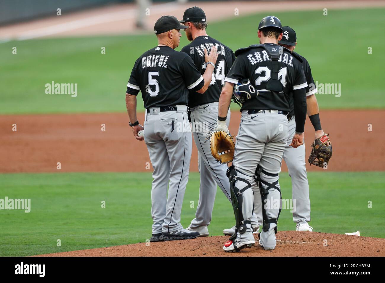 Chicago White Sox manager Pedro Grifol, left, and Pittsburgh Pirates  manager Derek Shelton, right, are separated by coaches after the benchs  cleared as a result of a home plate collision between Pittsburgh