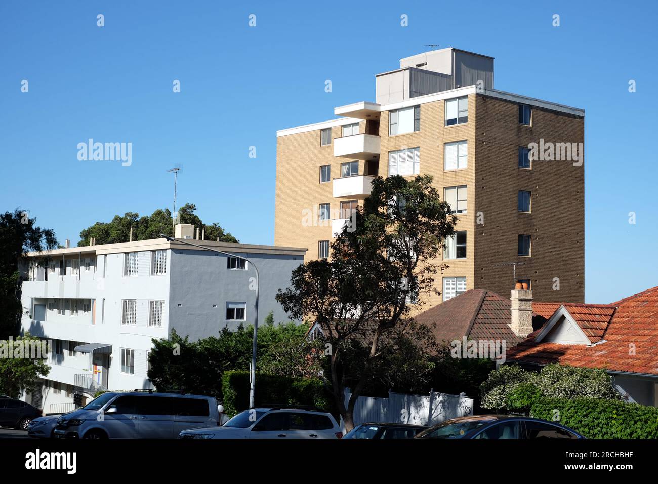 A brick apartment block tower dominates the skyline and older