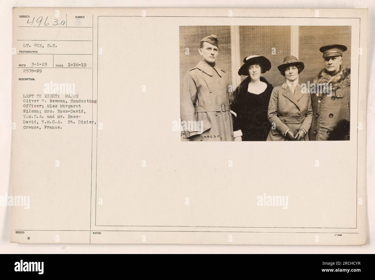 Left to right: Major Oliver P. Newman, Conducting Officer; Miss Margaret Wilson; Mrs. Ross-David, Y.M.C.A.; Mr. Ross-David, Y.M.C.A. St. Dizier, Creuse, France. This photograph, taken on January 16, 1919, shows the individuals mentioned in the description. Lieutenant Fox of the Signal Corps is also referenced in the details, although he is not pictured in this image. Stock Photo