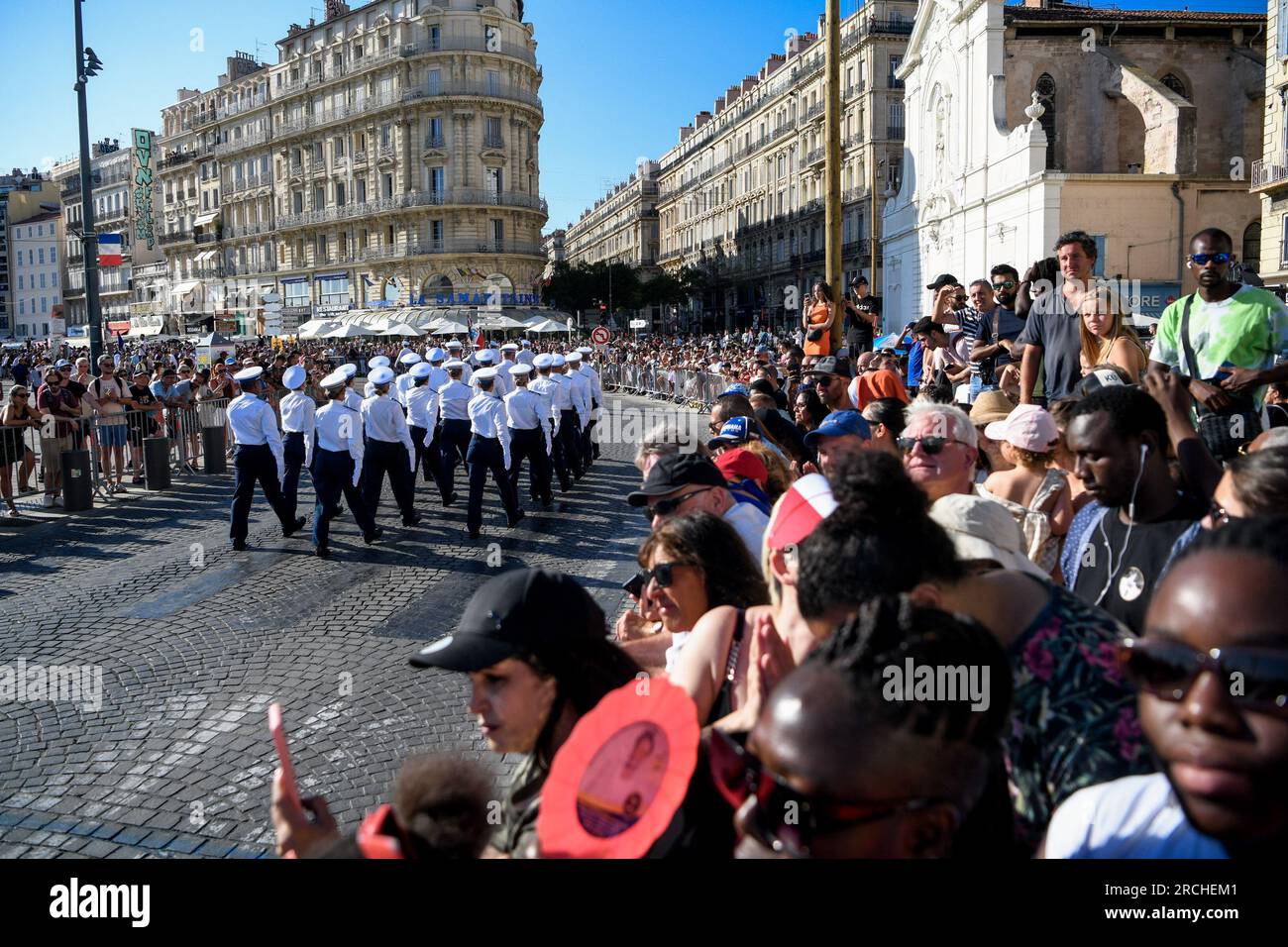 Security Parade A crowd of spectators gather to watch a military parade. Approximately ...