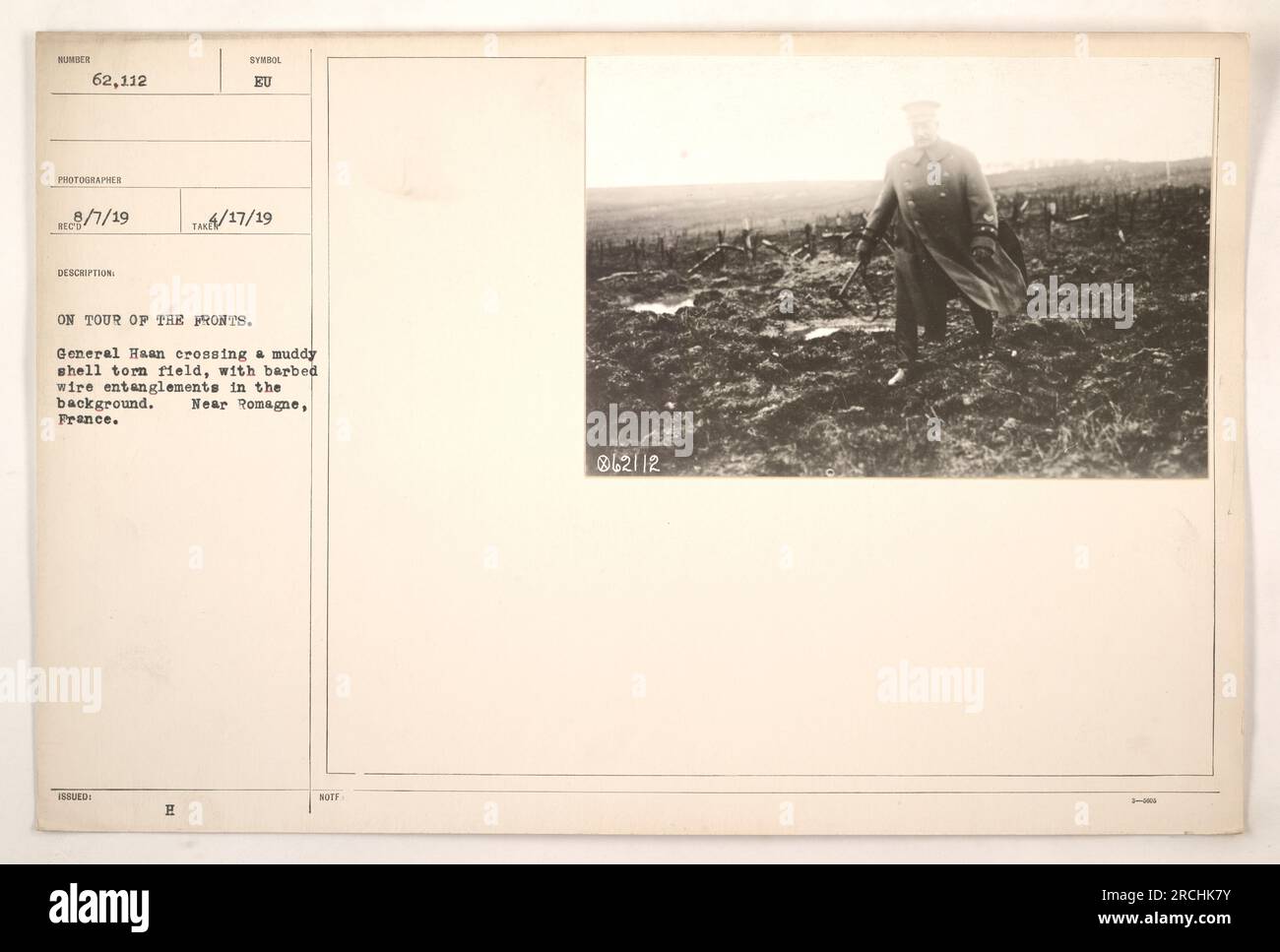 General Haan navigating a shell-torn field, accompanied by barbed wire entanglements in the background. The location of the photograph is near Romagne, France. The image was taken during World War One, as part of a series documenting American military activities. Stock Photo