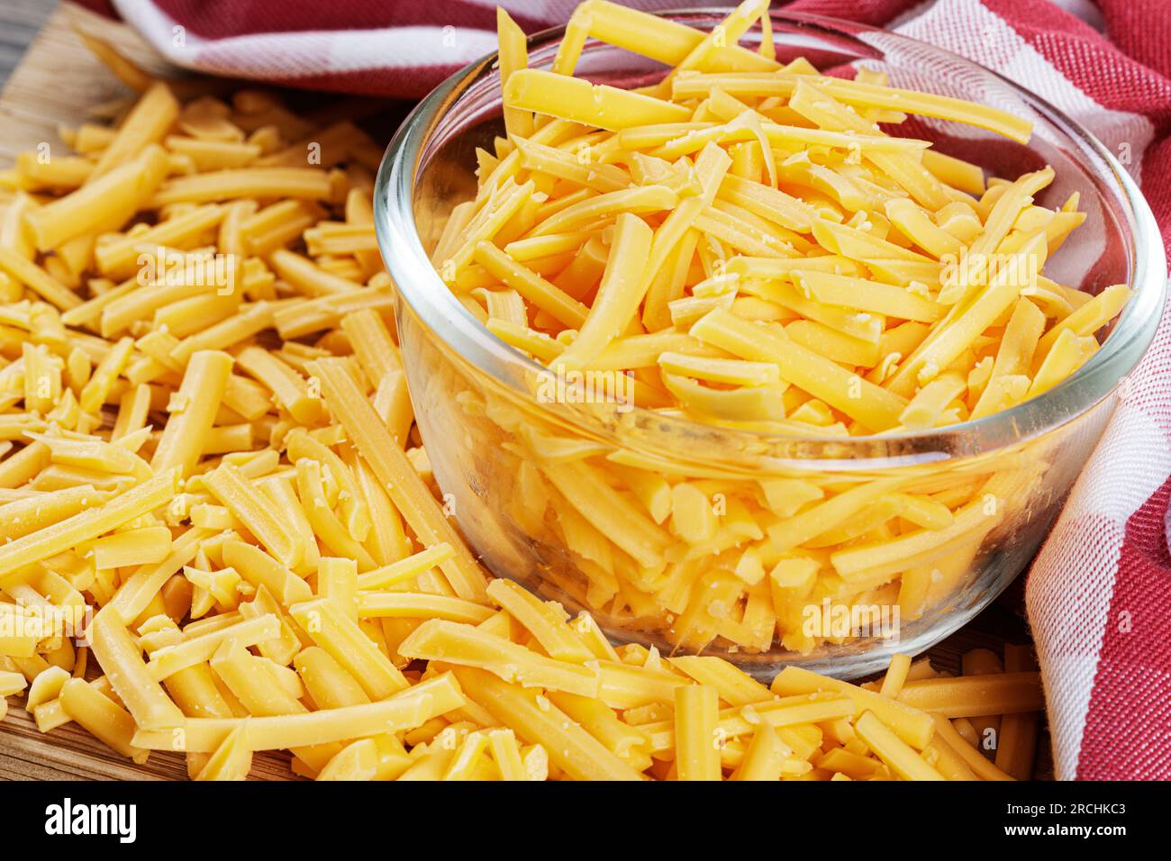 Close up of delicious Grated Cheddar Cheese on a wooden background with copy space Stock Photo