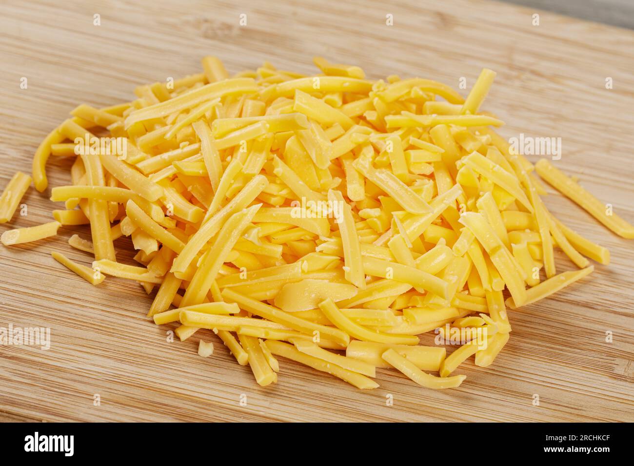 Grated cheddar cheese in plastic container Stock Photo - Alamy