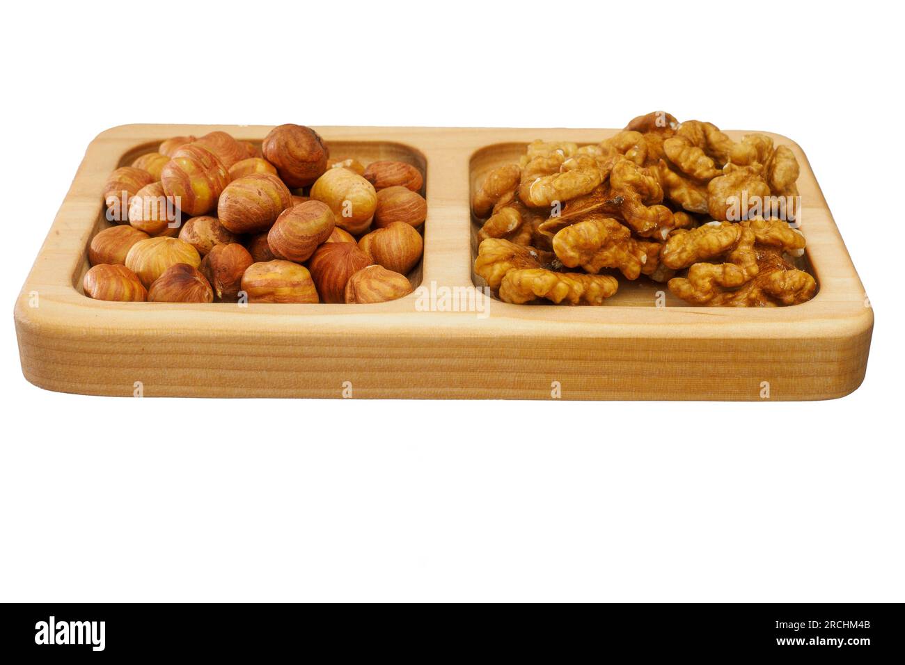 Wooden rack with assorted shelled nuts isolated on white background ...