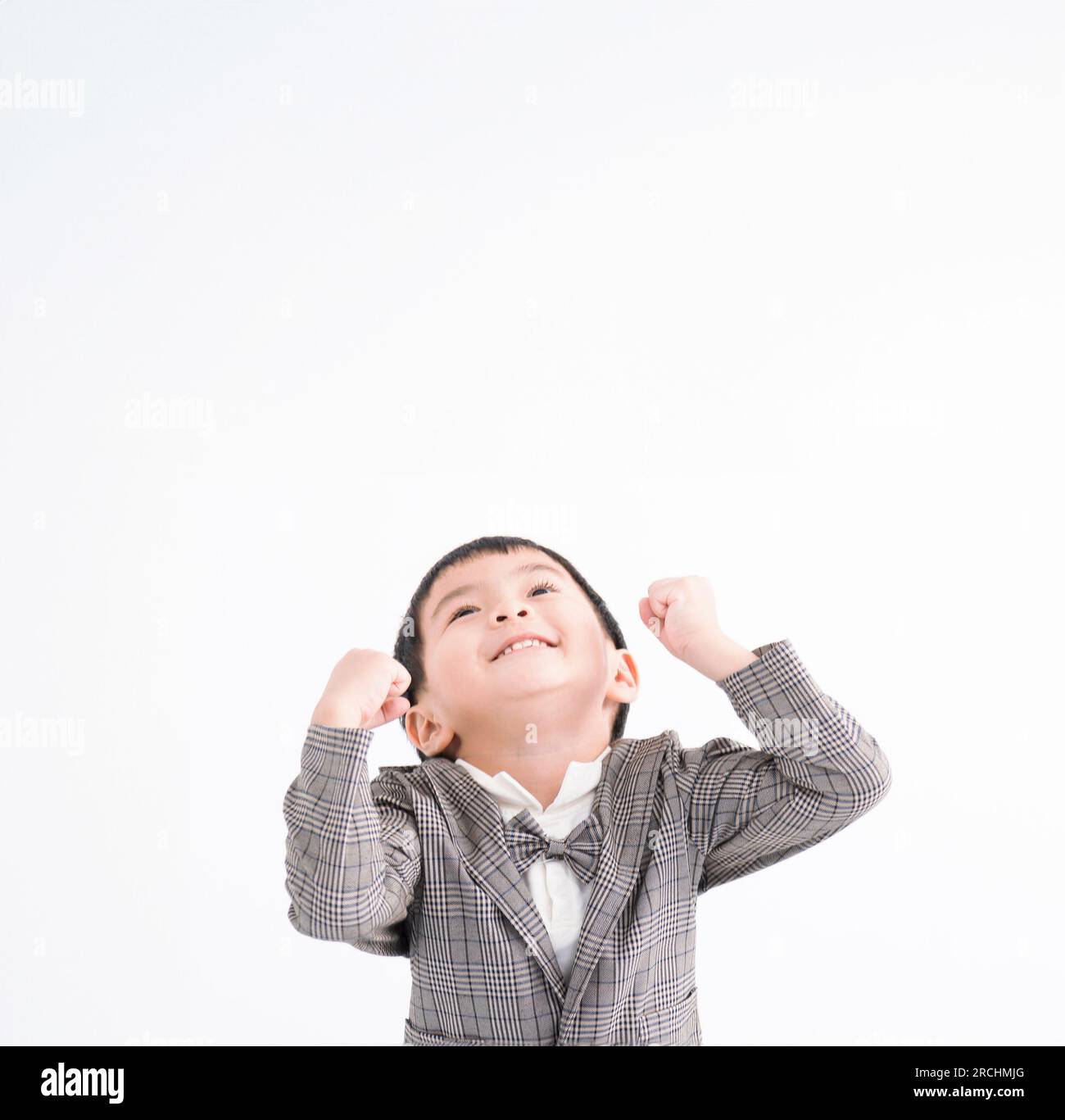 Excited kid looking up and isolated on white Stock Photo