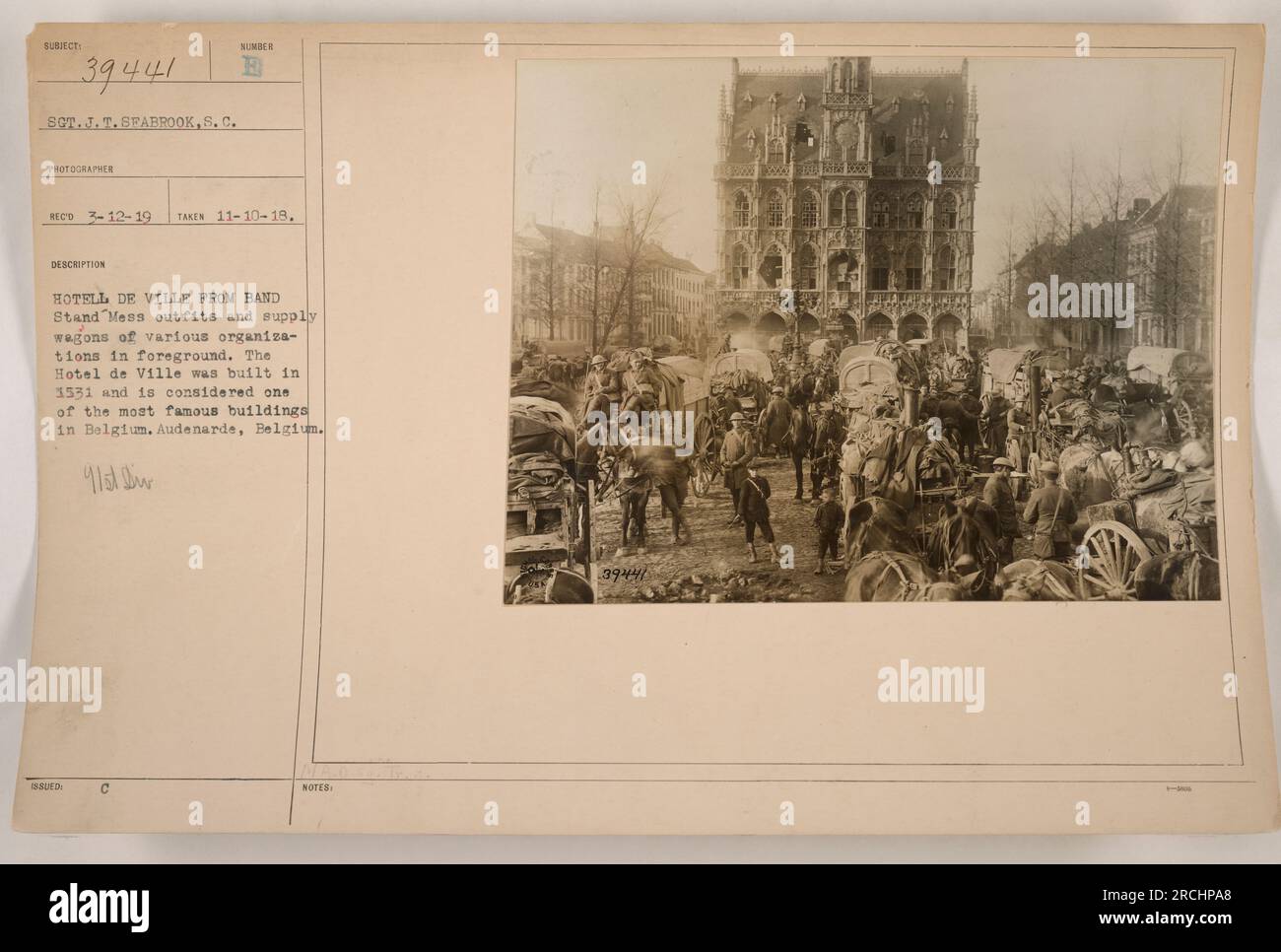 Image caption: 'Mess outfits and supply wagons of various organizations in the foreground, with the Hotel de Ville, a famous building in Belgium, in the background. The photograph was taken on November 10, 1918, in Audenarde, Belgium, during World War 1. (Photo ID: 111-SC-39441)' Stock Photo