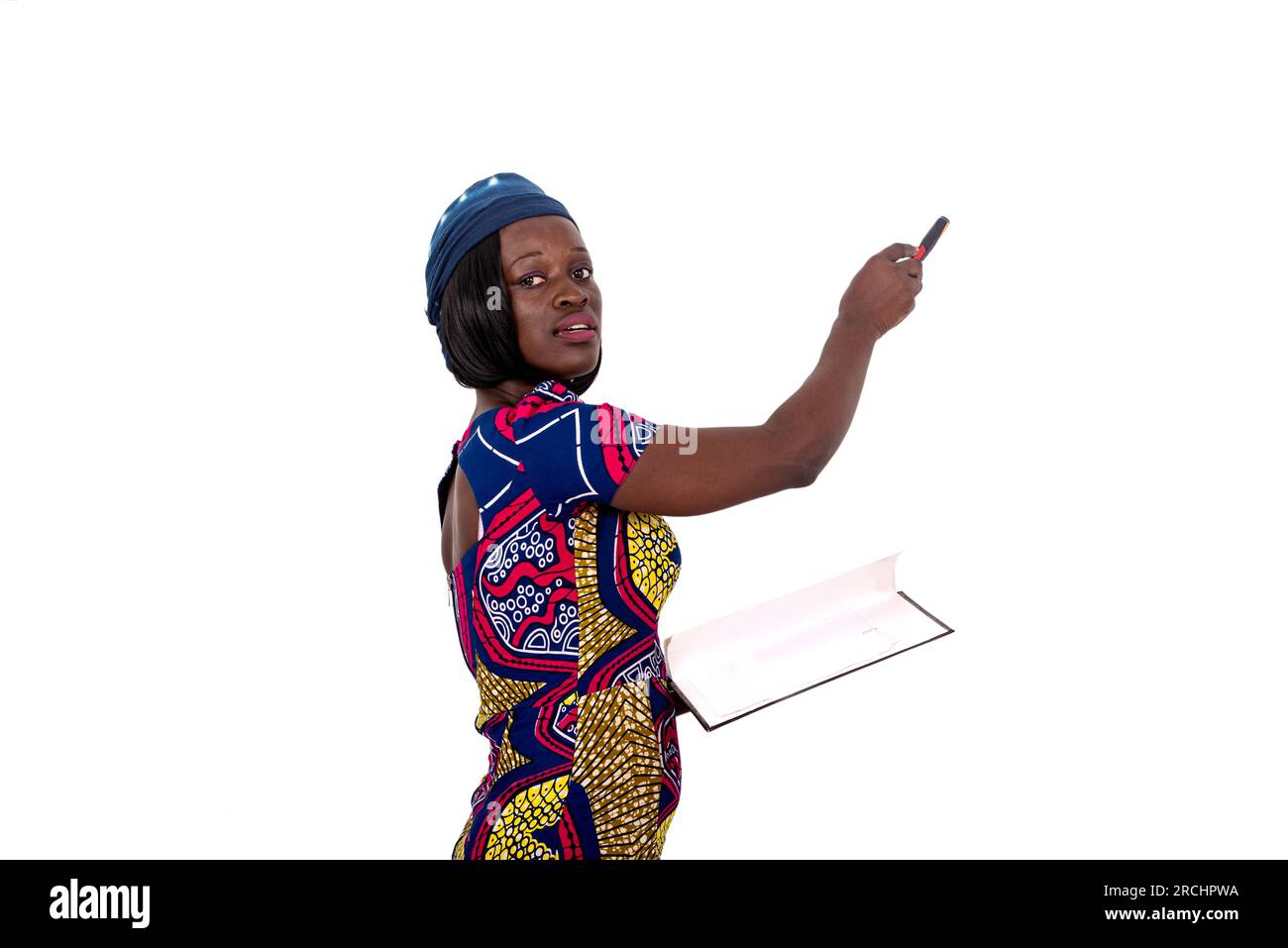 portrait of a beautiful young female teacher explaining the lesson on a whiteboard in a classroom. Stock Photo