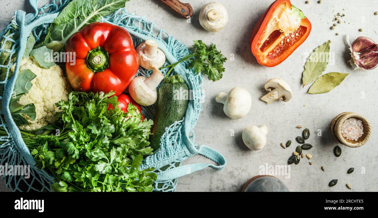 Sustainable grocery shopping with mesh bag and healthy cooking concept with organic ingredients, top view Stock Photo