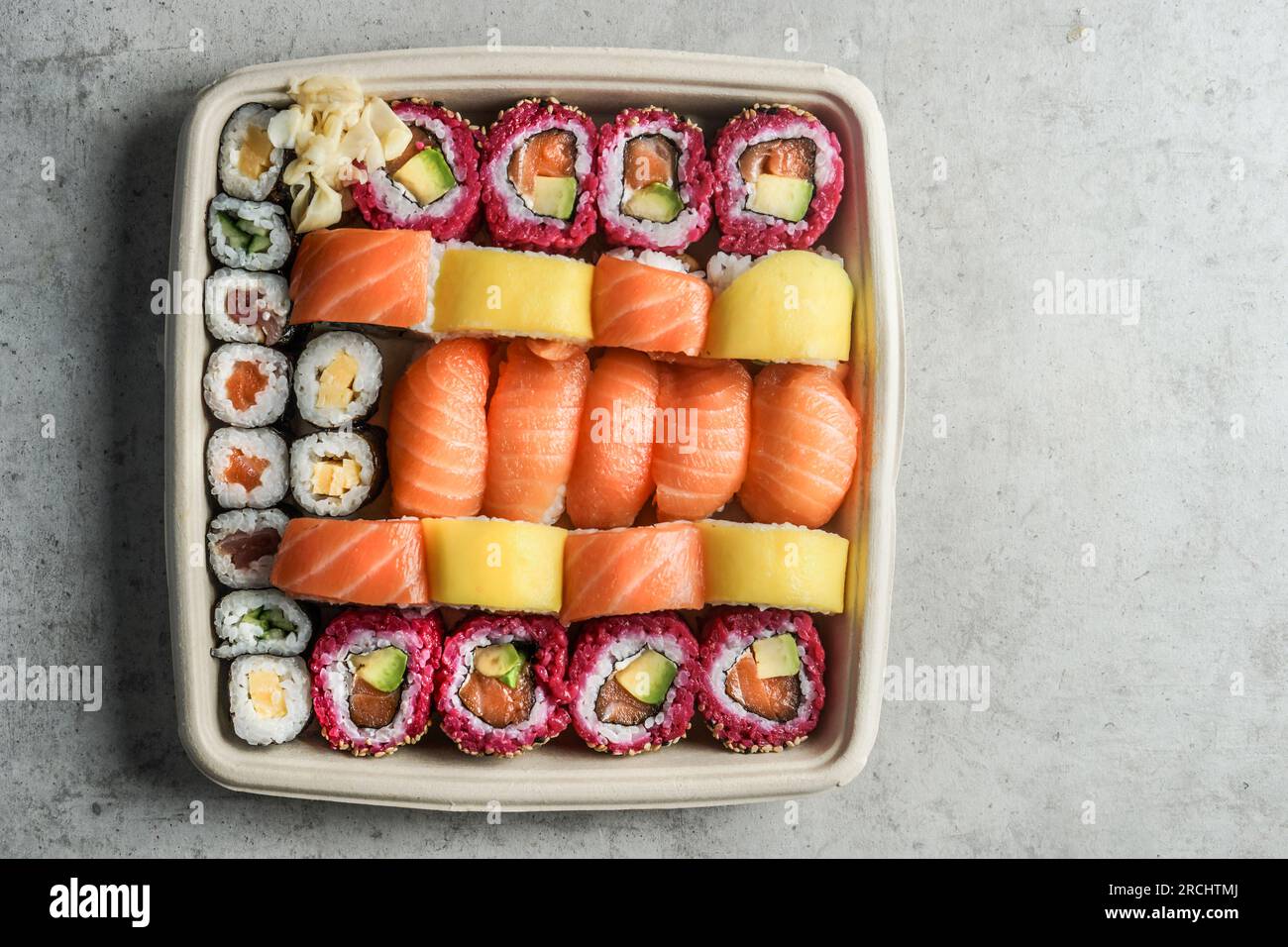 Take away sushi set in sustainable packaging on gray background, top view Stock Photo