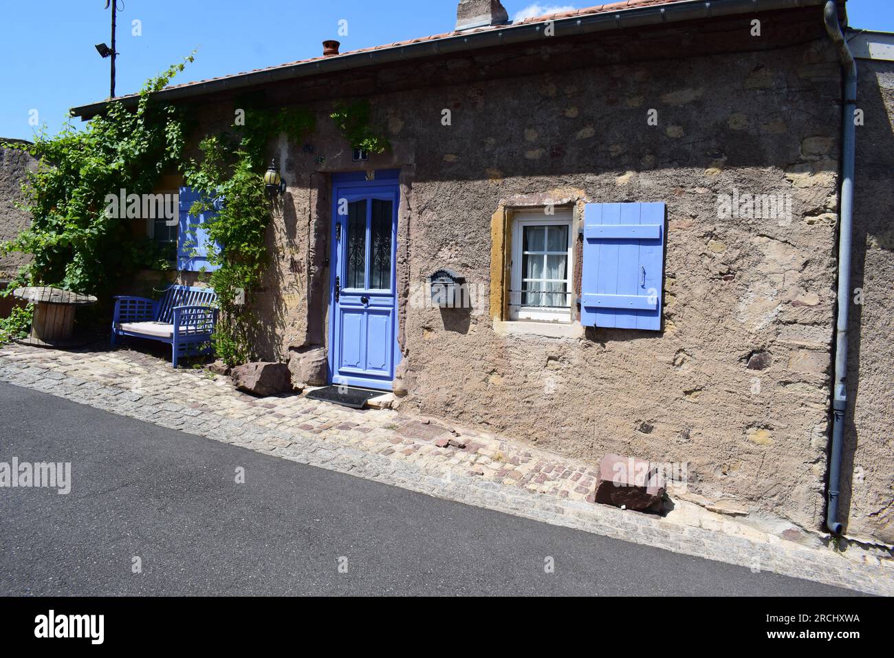 beautiful old stone house with light blue door and windows Stock Photo ...