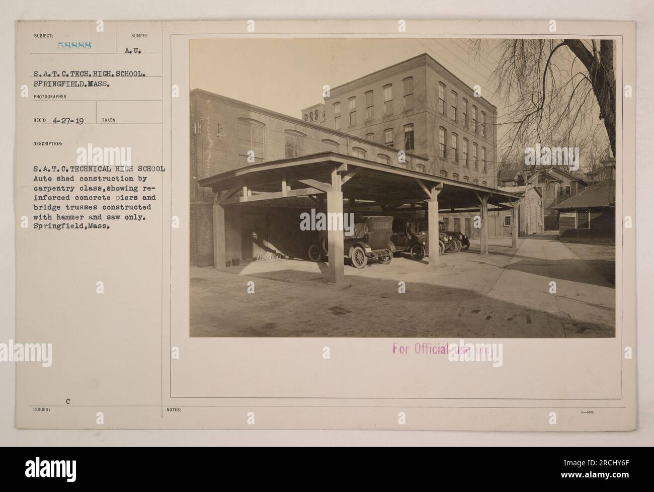 A photograph taken at the S.A.T.C. Technical High School in Springfield, Massachusetts, showing a construction project by the carpentry class. The image features reinforced concrete piers and bridge trusses being constructed solely with hammers and saws. This photo is marked for official use only. Stock Photo