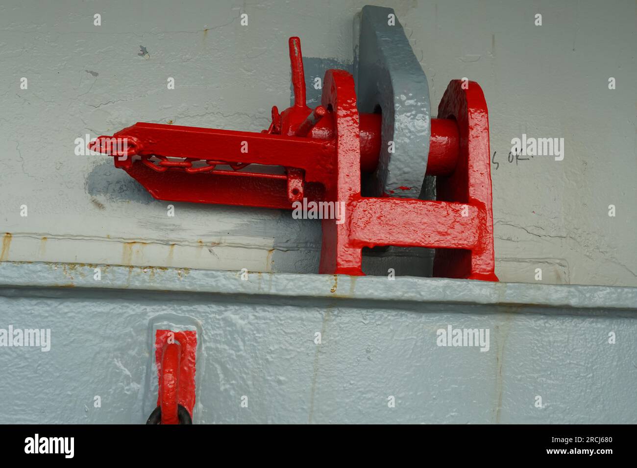 Red jumping stopper or securing cleat with chain used to secure